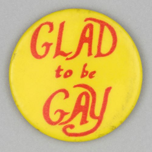 button badge stating Glad to be Gay in red font on yellow background